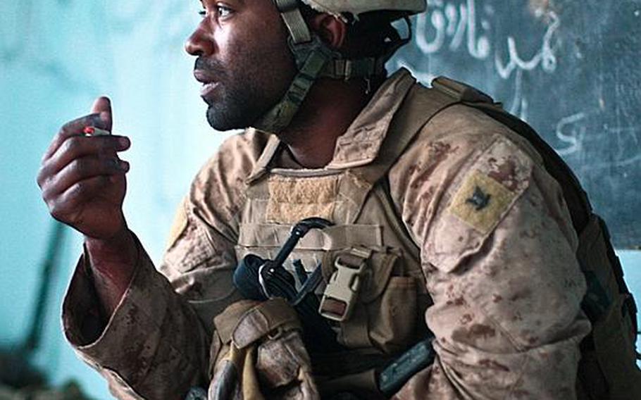 With his patient taken away, Navy Corpsman Jonathan Duhart takes a smoke break as he and his Marines try to dissect how the attack happened and how their fellow Marine was hit.