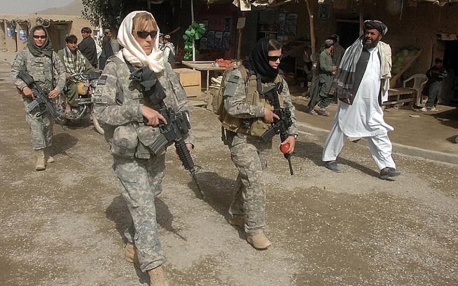 Female Engagement Team members Pfc. Kelly Shutka, 22, of Pine Glen, Pa., Pfc. Rachel Miller, 39, of Northumberland, Pa., and Sgt. Richelle Aus, 25, of Michigan City, Ind., patrol through a bazaar in Zabul province.