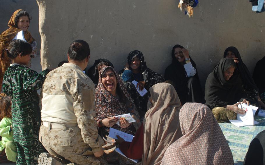 Interpreter Ira Quraishi, a member of one of the Marjah-area FETs, gets a laugh from a local woman who’d attended a Marine-sponsored meeting with a local midwife to inform the women about hygiene, pregnancy and child care issues.