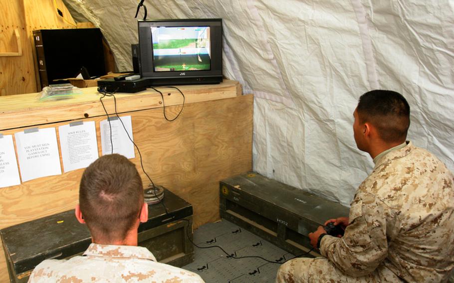 Marines play video games at a base in Afghanistan in this 2009 file photo. Doctors say troops who play video games to unwind after a long day in the field might not be getting enough sleep, and that this lack of sleep could lead to long-term mental problems. Some researchers think sleep deprivation could be a cause of the high suicide rate among military members.