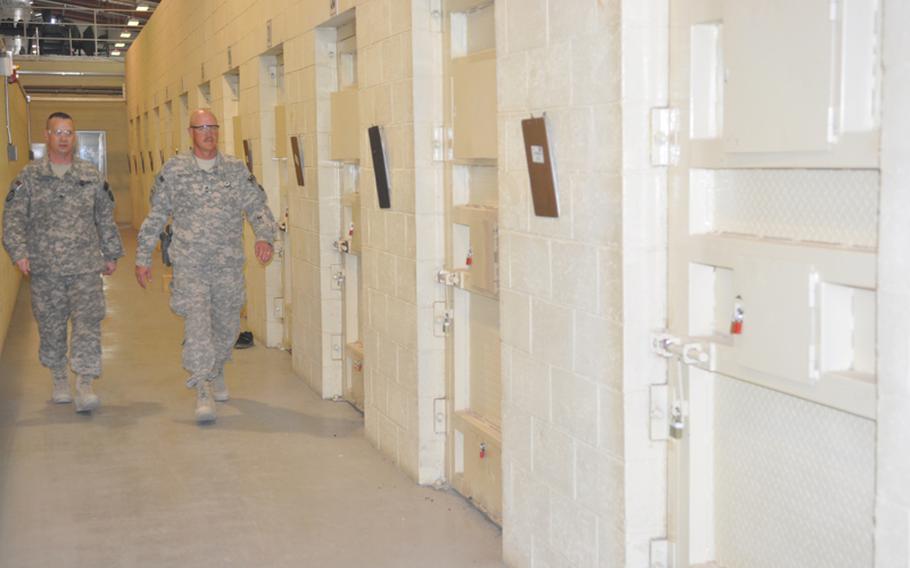 U.S. soldiers who serve as prison guards walk down the hall of the isolation cells at the U.S. detention facility in Parwan, on Nov. 24. Detainees at Parwan have hearings but do not get lawyers and cannot challenge their detention.