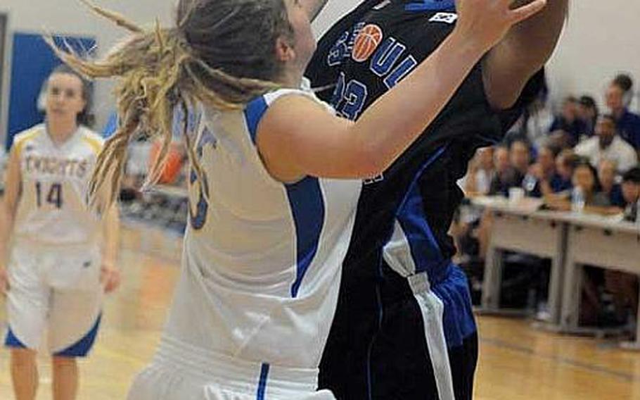 Seoul American&#39;s Mecca Perkins shoots over Christian Academy Japan&#39;s Kendra Peterson (5) during Monday&#39;s pool-play game in the 34th Far East High School Girls Division I Basketball Tournament at Naval Base Guam. The Falcons routed the Knights 53-12.