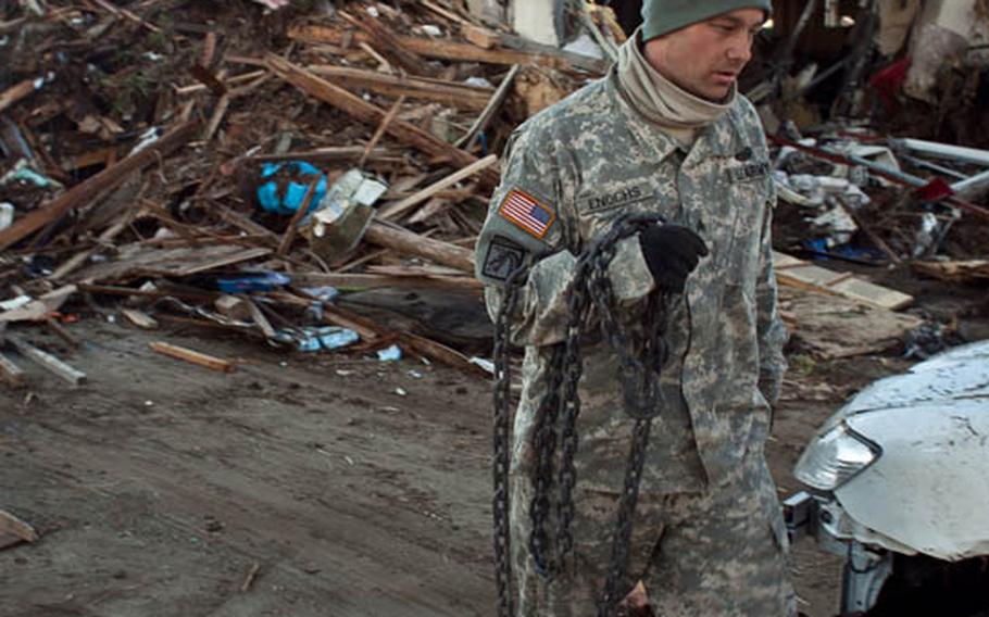 U.S. servicemembers help clear the Sendai Airport in Sendai, Japan, after it was severly damaged in a 9.0 earthquake and resulting tsunami. 