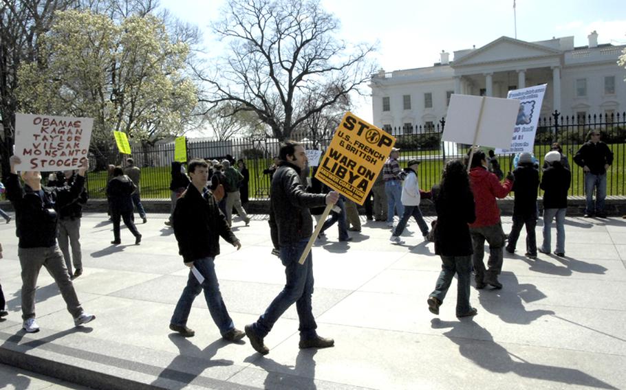 Anti-war and anti-genetically modified organisms protesters mingle as they march in front of the White House.