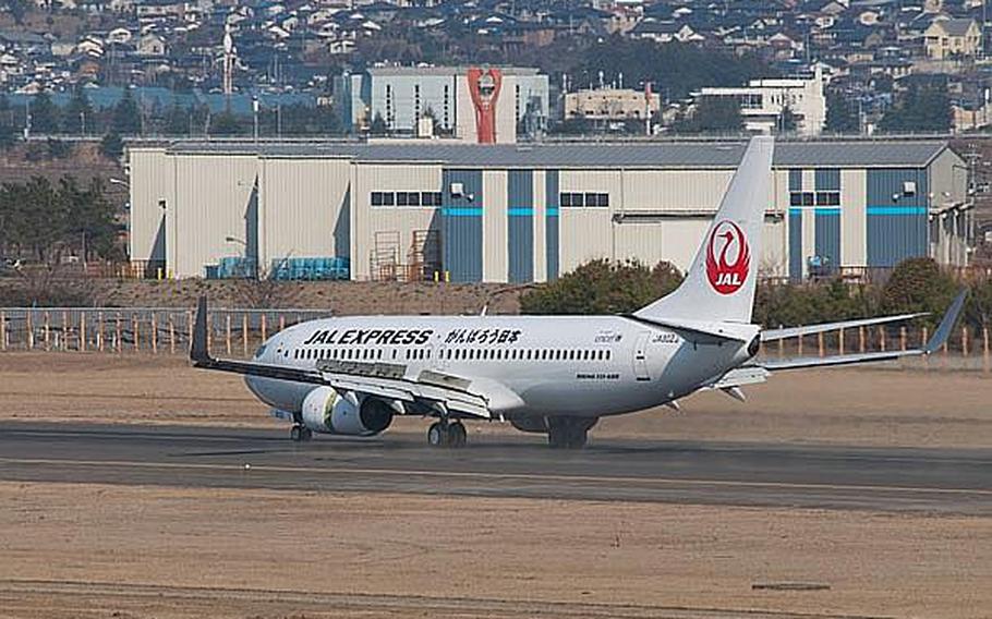 In this file photo, a Japan Airlines Express flight from Haneda Airport lands at Sendai Airport in Sendai, Japan, making it the first commercial flight to the airport since the March 11, 2011, tsunami ravaged the airport and region.  