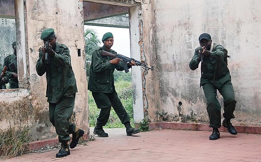 In the military camp in Kisangani, soldiers perform room-clearing exercises in the dilapidated old Belgian army officer quarters. These soldiers have been selected to serve as future trainers at the camp. The U.S. hopes that the base will evolve into a training center, where the Congolese can run military instruction programs on its own.