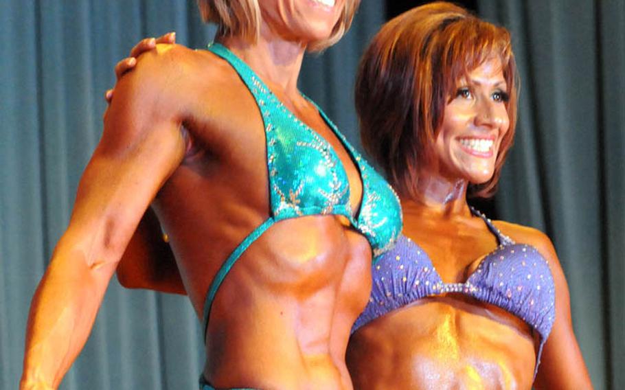 Women's figure champions, 5-foot-3 and over Stacy Tews and 5-3 and under and overall winner Ivette Kragel in Sunday's 5th Pacific Muscle Classic bodybuilding, fitness and figure competition at Keystone Theater, Kadena Air Base, Okinawa.