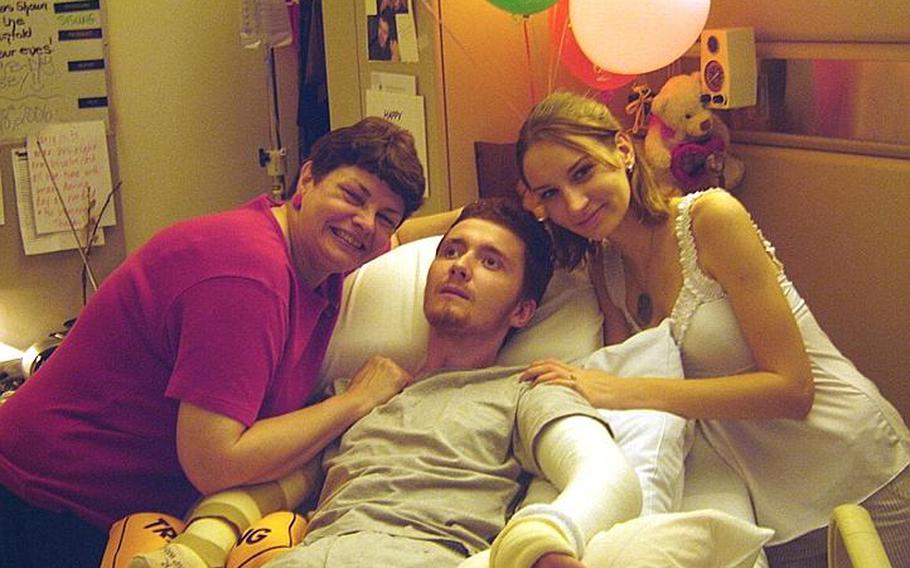 Yuriy Zmysly, a former Marine, celebrates his 22nd birthday after waking up from a three-month coma in a Chicago hospital. His wife Aimee Zmysly, right, said he was stricken with brain damage due to medical mistakes made at a military hospital in Cherry Point, N.C.
