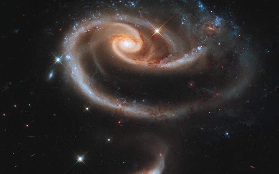 To celebrate the 21st anniversary of the Hubble Space Telescope&#39;s deployment into space, astronomers at the Space Telescope Science Institute in Baltimore pointed Hubble&#39;s eye at an especially photogenic pair of interacting galaxies called Arp 273.