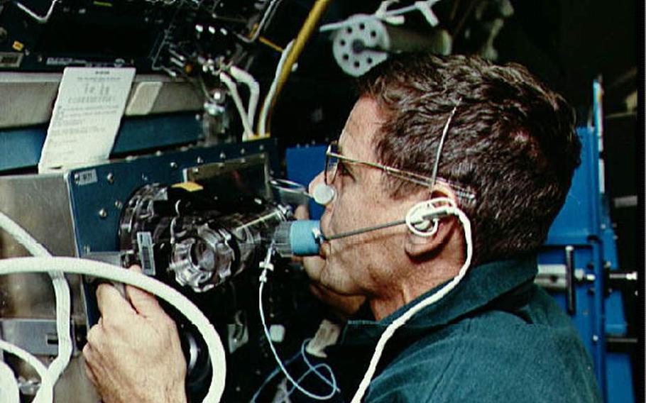 During a 1993 space shuttle flight, astronaut William ''Bill'' McArthur uses a rebreather in an experiment measuring how gases distribute through the blood while in space.