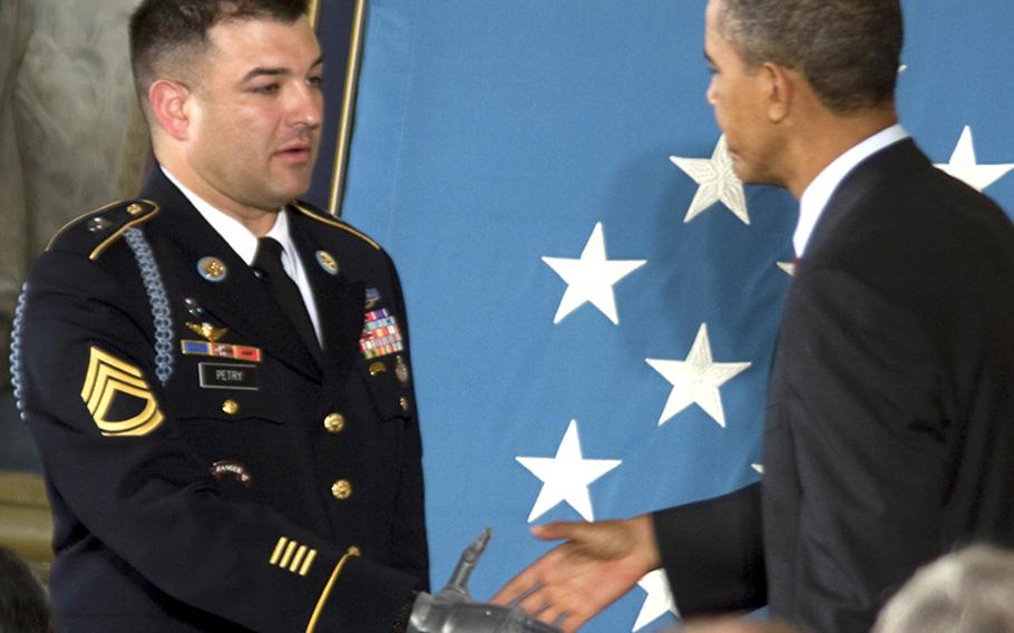 President Obama congratulates Sgt. 1st Class Leroy Petry before presenting him the Medal of Honor.