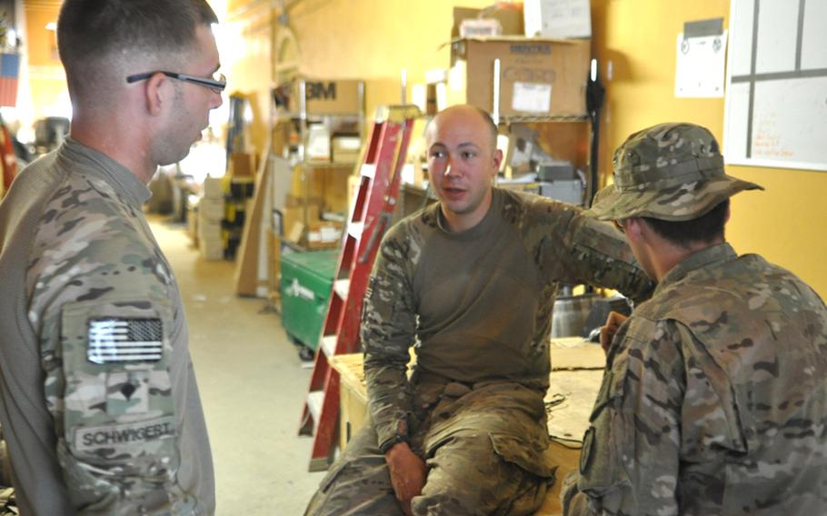 Sgt. Misha Pemble-Belkin, center, meets with two members of his platoon team, Spc. Steven Schwigert, left, and Pfc. Kevin Amick, at Combat Outpost Monti in Kunar province in eastern Afghanistan.