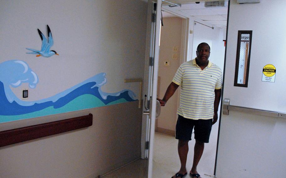 Maj. Shabon Shelton, a psychiatric nurse, walks out the same doors on the third floor of Fort Benning&#39;s hospital that he did on Sept. 6, 2010, when he entered a hostage situation to try to calm down retired Army Sgt. Robert Quinones. Quinones had entered the hospital with four guns, demanding mental health treatment.