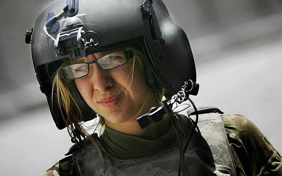 Flight medic Cpl. Amanda Mosher, of the 563rd Aviation Support Battalion, 159th Combat Aviation Brigade, 101st Airborne Division, pauses after a mission on June 15, 2011, at Forward Operation Base Pasab in Afghanistan.