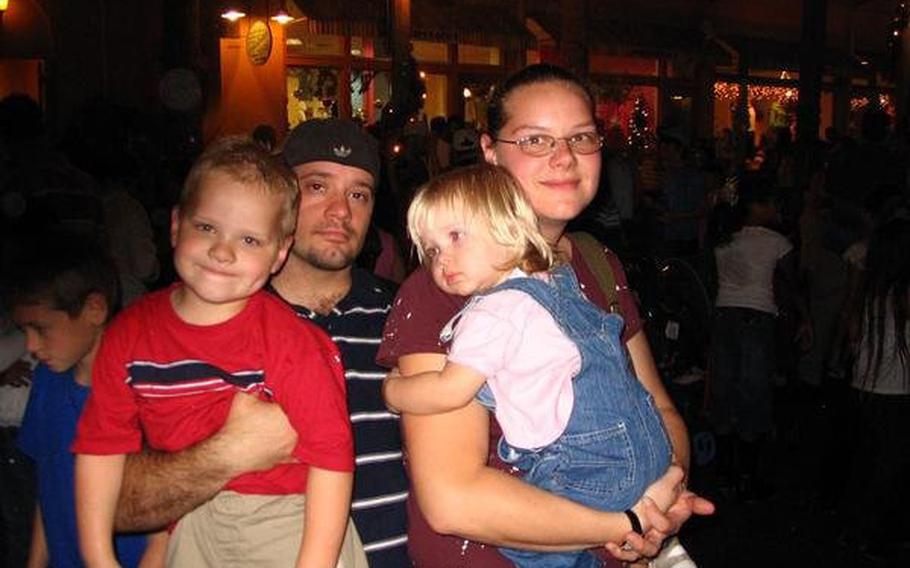 Nekl Allen and his wife, Amy, pose with their children Michael and Grace during a 2007 trip to Florida.