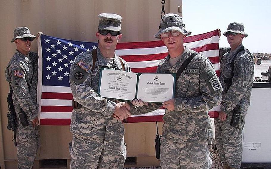 Then-Spc. James Coleman, right, re-enlists in Iraq during his third deployment in 2007.