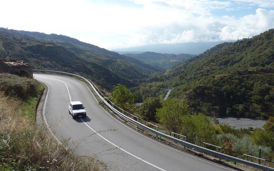S 185, a serpent of a road, climbs from the Ionian Sea at Giardini-Naxos to well over a 1,000 meters near Novara di Sicilia, then winds back down to the Tyrrhenian Sea near Castroreale Terme. From here, you can follow the coastal road to Tindari. In good weather conditions it is a beautiful alternative to the Autostrada. At center, Mount Etna is obscured by clouds.