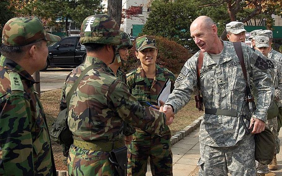 Maj. Gen. Edward C. Cardon, the commander of the 2nd Infantry Division, center, is greeted by South Korean Army personnel as he arrives at a Korean base near Gimpo in November of 2011.
