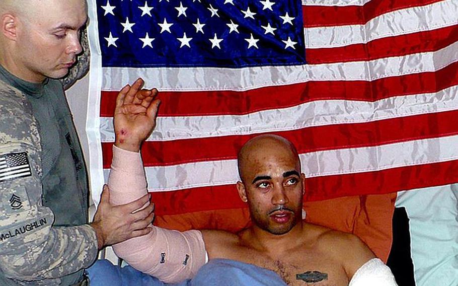 Daryl Williams, center, reenlists in the Army from his hospital bed in Baghdad.