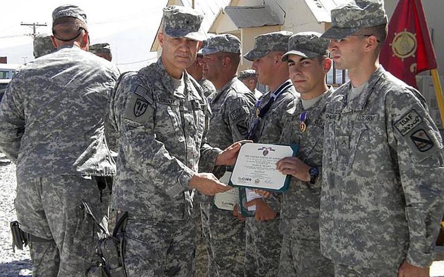 Then Spec. Joseph Allen, second from right, is awarded the Purple Heart in Afghanistan in 2009.