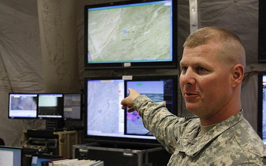 Maj. James Hite shows some of the systems used to monitor operations at the Army Network Integration Exercise's brigade tactical operations center at White Sands Missile Range, N.M., on Nov. 16. 2011.