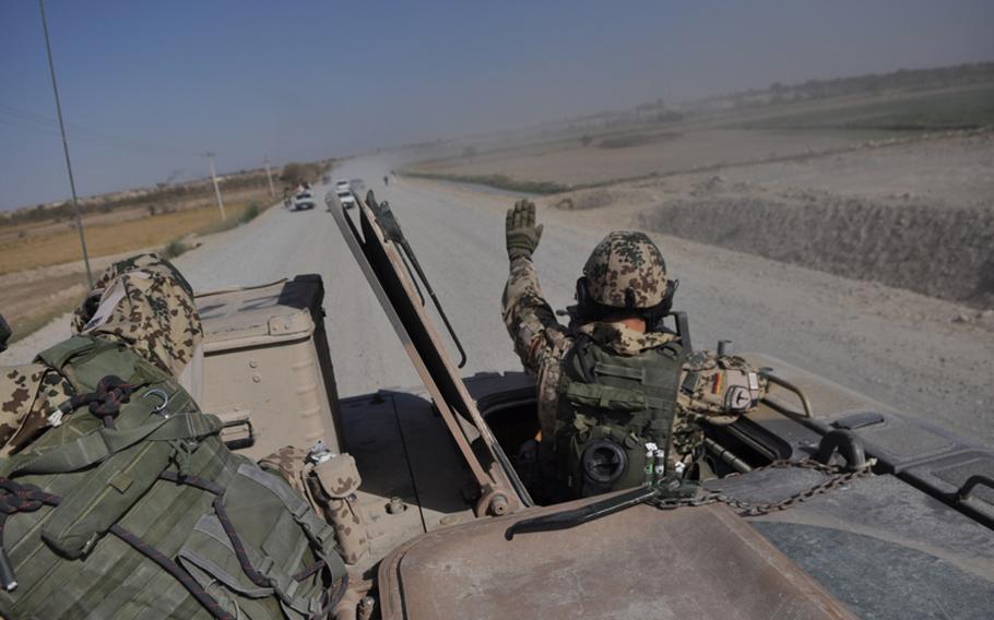 A German soldier warns a driver to keep away from their convoy near the city of Kunduz in northern Afghanistan.