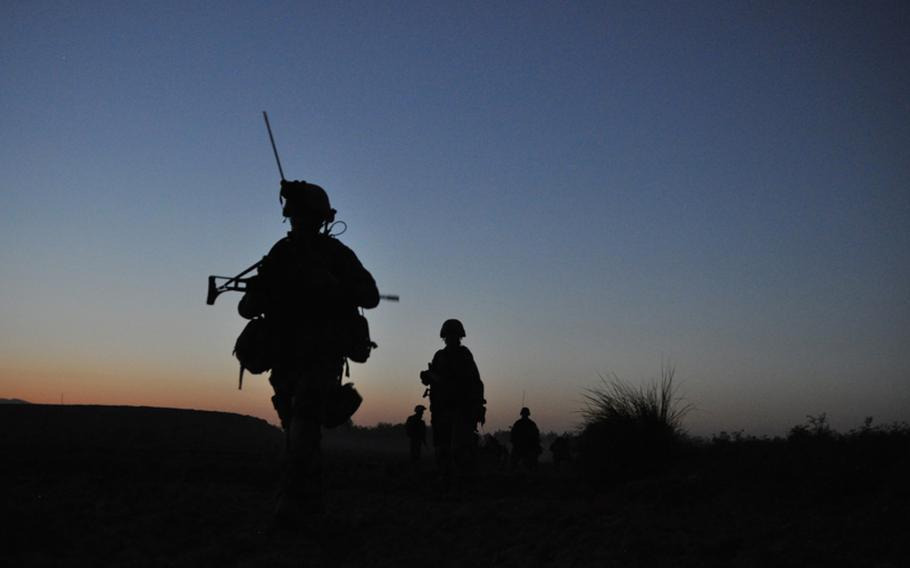 German soldiers finish a patrol at dusk in the Char Dara district, Kunduz province, Afghanistan.