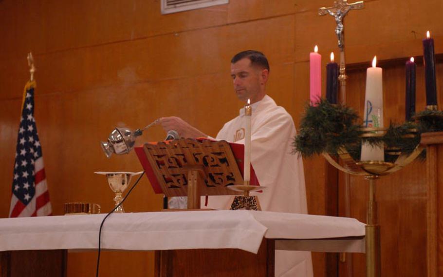 Capt. Joel Panzer fills the chapel at Iraq's Camp Liberty with the smell of incense during a Christmas Mass in December 2010.