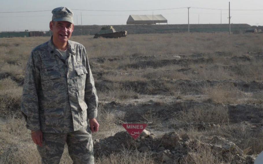 Col. Steven Brosk, a Catholic chaplain in the U.S. Air Force, poses near a mined field in Afghanistan in 2010.