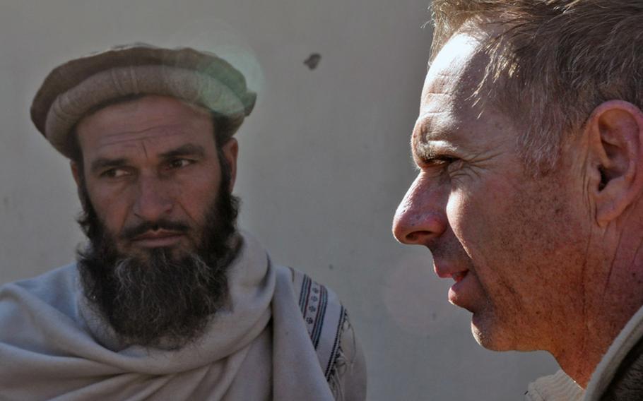 Lt. Col. Dan Wilson, right, met with local officials and tribal elders in the village of Nishigam in Kunar province days after a Dec. 9 suicide bombing outside a nearby mosque killed six people, including the police chief.