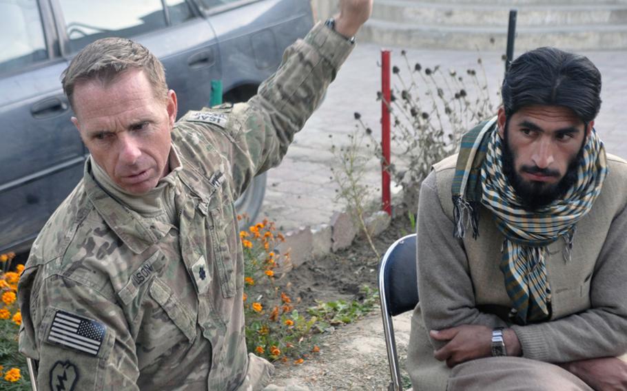 Lt. Col. Dan Wilson, left, met with Abdul Wahab, district subgovernor of Ghaziabad, and other local officials days after a Dec. 9 suicide bombing outside a mosque in the village of Nishigam in Kunar province killed the local police chief and five other people.