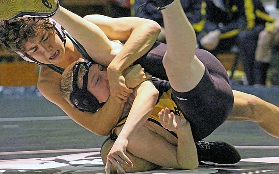 Mike Brown of Kubasaki gets a cradle hold on Kadena's Cole Milburn during Wednesday's 115-pound bout in the Okinawa Activities Council dual meet at Kubasaki High School. Milburn rallied to win a two-period decision, but Kubasaki won the dual meet 32-24.