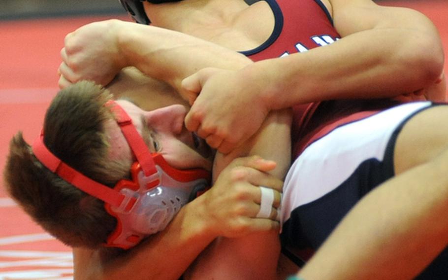 Menwith Hill's Alex Abing, top, puts the squeeze on Kaiserslautern's Erik Langholz in their 145-pound match in Kaiserslautern on Saturday. Abing won the match with a fall at 5:03.