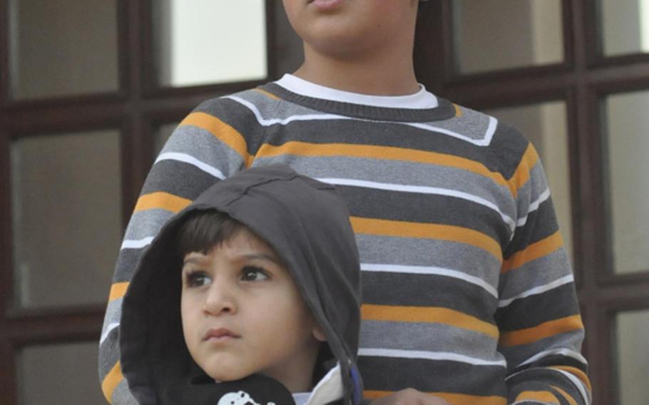 Bahraini children stand outside the headquarters of al-Wefaq, the country&#39;s main opposition group and one that has been pushing for equality for the island nation&#39;s disenfranchised Shia majority. Earlier in the day, police fired tear gas and rubber bullets at the building and protesters.