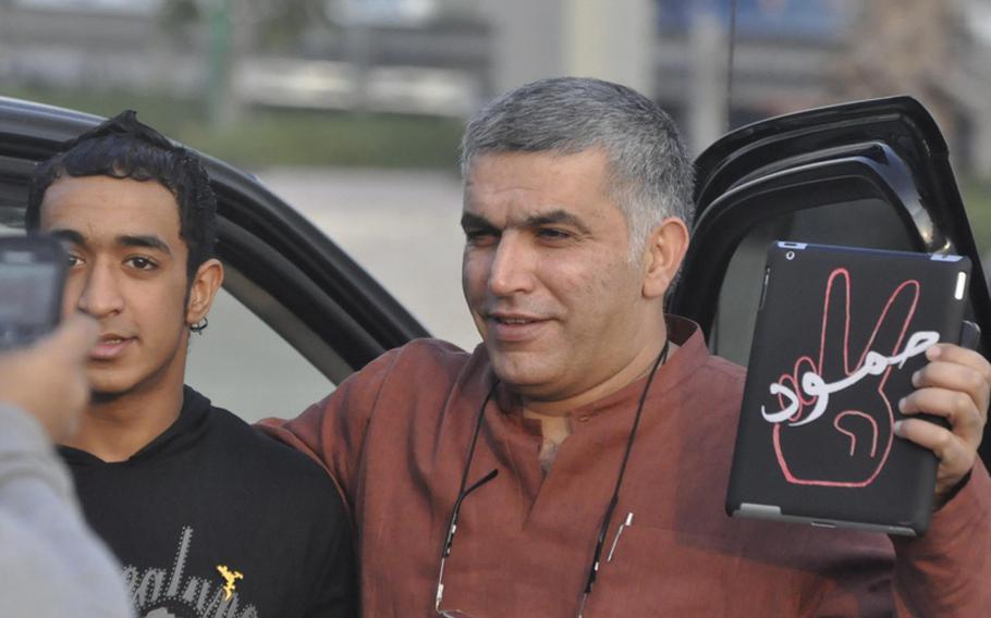 Nabeel Rajab, head of the Bahrain Center for Human Rights, poses with a protester Dec. 23 outside the headquarters of al-Wefaq, the country&#39;s main opposition group. Rajab says he has been regularly harassed, beaten and kidnapped by Bahraini police. Rajab and other activists say that, despite the government&#39;s heavy-handed response to the largely peaceful protests, they will not stop until there is equality in Bahrain and the ruling monarchy becomes largely ceremonial.