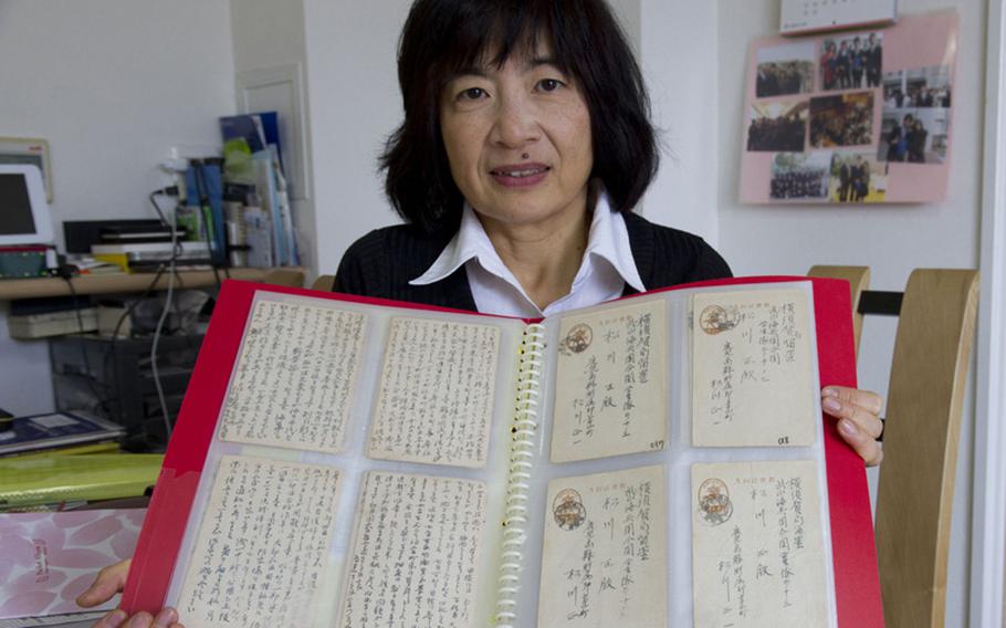 Naoko Tomioka holds letters her uncle, Tadashi Matsukawa, wrote during the battle of Iwo Jima in 1945. The letters were found by U.S. sailor Vic Voegelin, and he kept them as souvenirs before returning them to Tomioka’s family in 2007.
