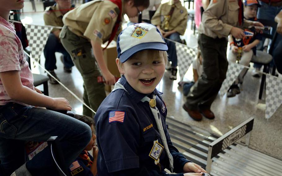 Lucas Kemp, 9, reacts to his car winning another heat Saturday afternoon during the Barbarossa District Cub Scouts pinewood derby championships at the KMCC on Ramstein Air Base, Germany. Kemp went on to be the overall district champion.