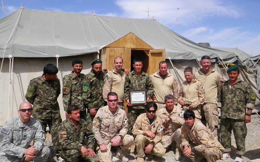 Capt. D.J. Skelton, left, poses with Afghan and Canadian soldiers in spring 2011. Skelton, who had been grievously wounded in Iraq in November 2004, worked for seven years to stay in the Army and return to the infantry.
Courtesy of D.J. Skelton