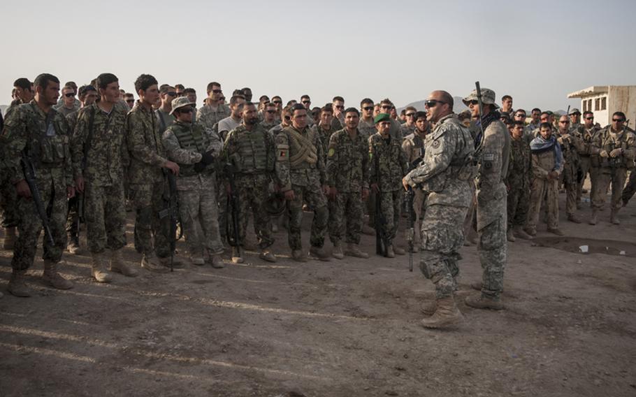 Capt. D.J. Skelton, hatless and wearing sunglasses, addresses U.S., Afghan and Canadian soldiers after a mission in Nakhony, Afghanistan in April 2011. Skelton was badly wounded in Iraq in November 2004, but recovered to rejoin the infantry and commanded Comanche Troop, 1st Squadron, 2nd Stryker Cavalry Regiment in Afghanistan last year.