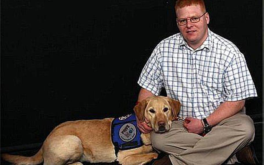 Jacob Manning poses with his service dog, Harley.