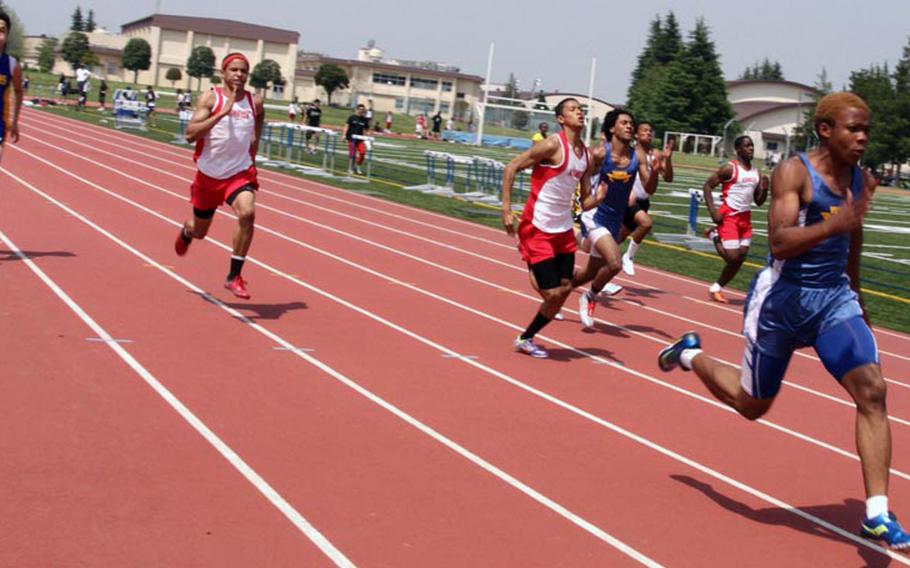 Yokota's Preston Brooks leads the pack to the finish line of the 100-meter dash during Saturday's Kanto Plain Association of Secondary Schools track and field finals at Yokota Air Base, Japan. Brooks was timed in 10.98 seconds, third-fastest in the Pacific this season.