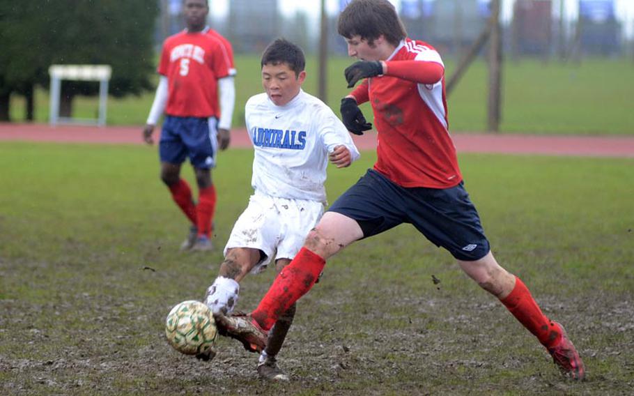 Menwith Hill's Schuyler Backlar, right, steals the ball from Rota's Kris Rios during DODDS-Europe Division-III play at RAF Alconbury, England, on Saturday. Backlar scored the only goal of the match for the Mustangs.