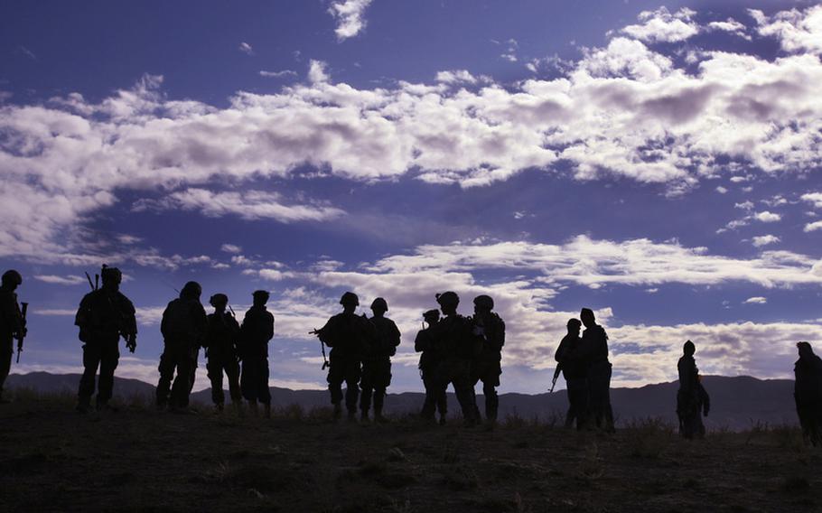 Pathfinders with Company F, 4th Battalion, 101st Aviation Regiment, 159th Combat Aviation Brigade, 101st Airborne Division, assemble after being dropped by Chinook helicopter for a mission in Zabul province, Afghanistan on Dec. 1,  2011.
