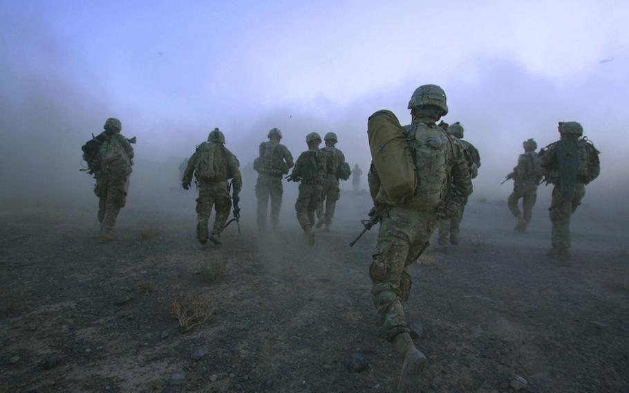 Pathfinders with Company F, 4th Battalion, 101st Aviation Regiment, 159th Combat Aviation Brigade, 101st Airborne Division, move away from a Chinook helicopter after being dropped in for a mission on Sept. 23, 2011, in Zabul province, Afghanistan.