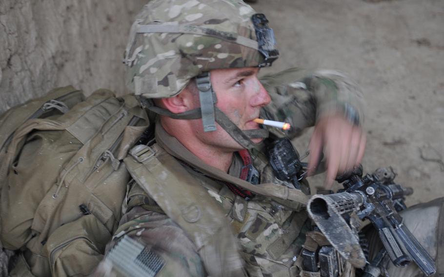 Staff Sgt. Cody Ferlicka stops for a smoke break outside the village of Salim Aka, in Kandahar province shortly before a bomb tore through a group of U.S. and Afghan soldiers, killing one American and two Afghans.