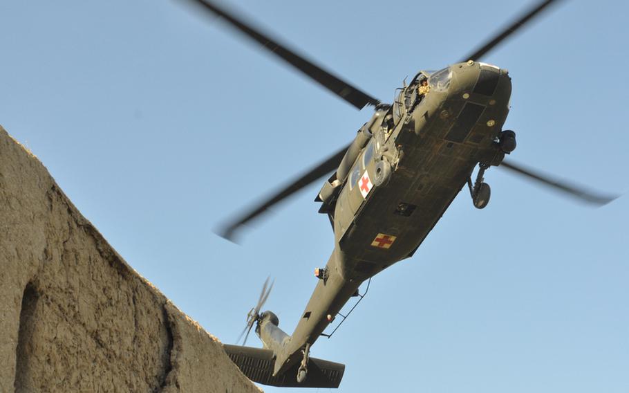A MEDEVAC helicopter arrives to pick up soldiers wounded in a bomb blast April 25 in the village of Salim Aka in Kandahar province. Three soldiers were killed in the blast.