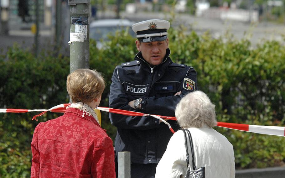 A police officer talks to two pedestrians who wanted to enter the evacuation zone in downtown Kaiserslautern, Thursday, where experts were working to defuse an American World War II-era, 250-pound bomb. About 3,500 residents were evacuated from the zone that extended about 330 yards around the site. The defusing that was suppose to last about half an hour took nearly an hour longer because the threads on one of the bomb’s two fuses were misaligned.