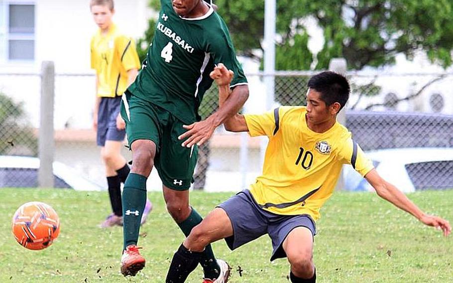 Kubasaki's Dillon Demmott, left, battles Guam High's Fred Alig for the ball during Monday's pool-play match in the Far East High School Boys Division I Soccer Tournament at Camp Foster, Okinawa. Kubasaki blanked the Panthers 4-0 behind Demmott's two goals.