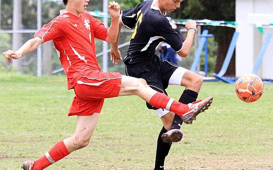 Nile C. Kinnick's Branden Yoder and Kadena's Gregory Borgert battle for the ball during Monday's pool-play match in the Far East High School Boys Division I Soccer Tournament at Camp Foster, Okinawa. The Panthers edged the Red Devils 1-0.