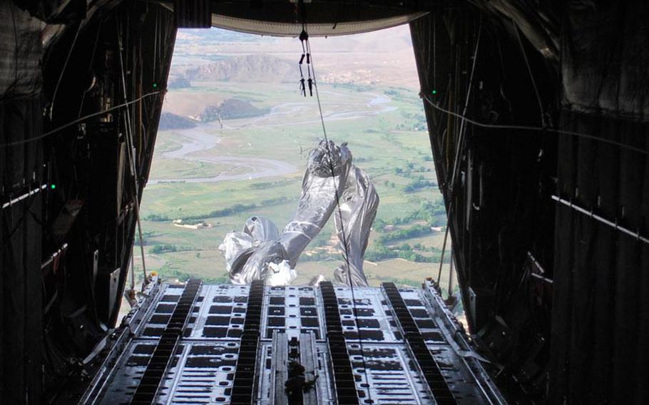 Parachutes unfurl 1,000 feet above Afghanistan's Khod Valley as supply bundles fall from the cargo door of a C-130. The Air Force airdrop mission north of Kandahar last month restocked a remote Army base with food, water and ammunition.